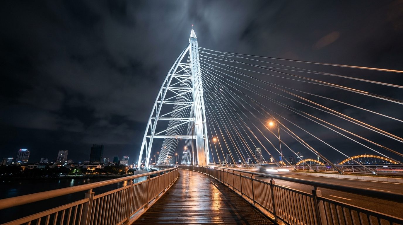 Tran Thi Ly Bridge sail tower illuminated white at night, wide angle upward shot from walkway