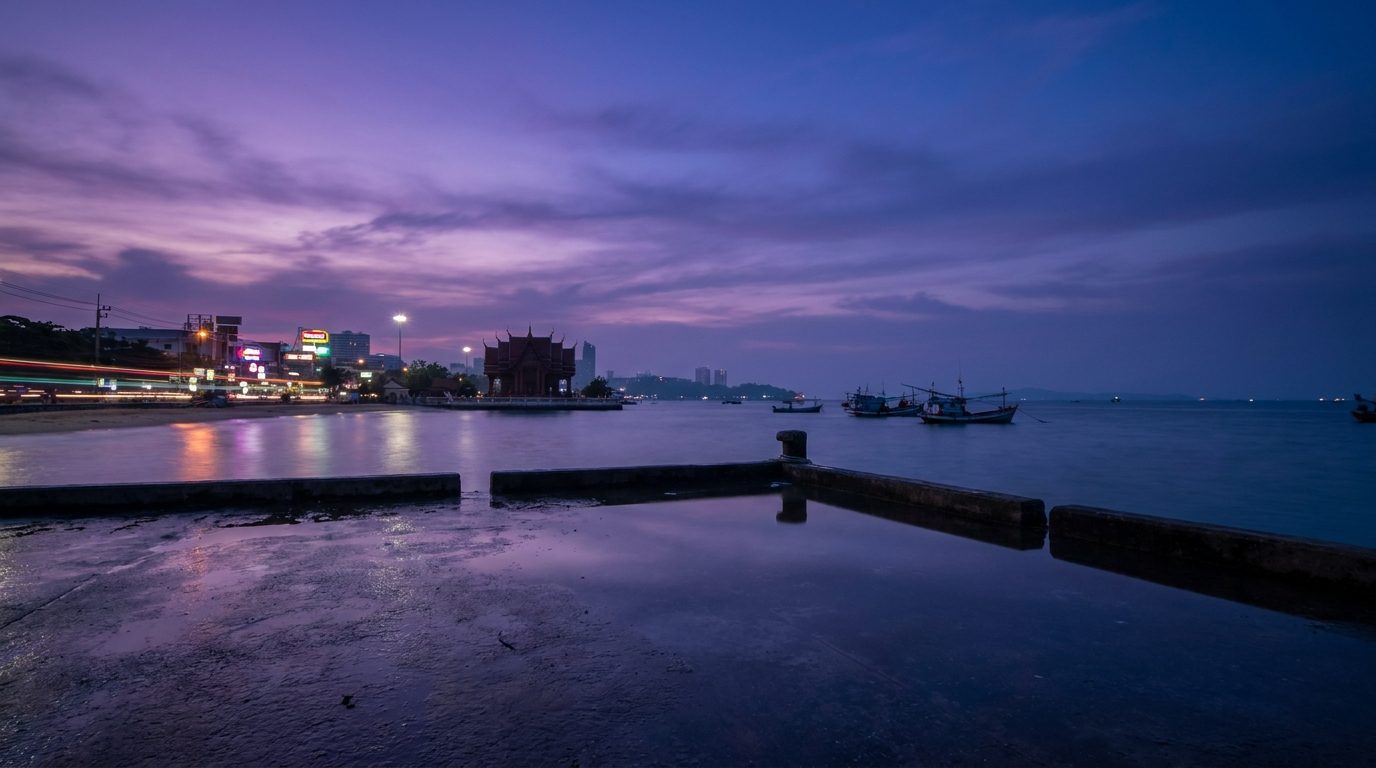 Bali Hai Pier at pre-dawn, long exposure, purple sky reflecting on wet concrete, Pattaya